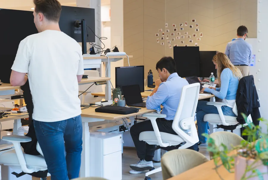 Team members working at standing desks
